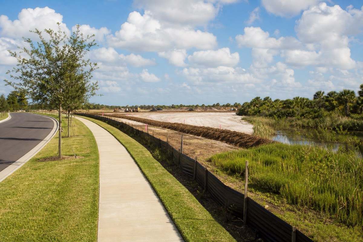 Graded building pads on cleared former ranchland at the construction edge of a Viera master-planned neighborhood